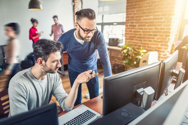 Front End Developer showing work to his manager